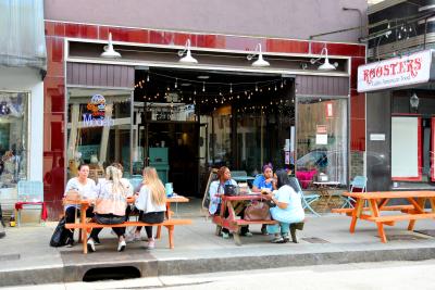 Groups of people seated at picnic tables eating