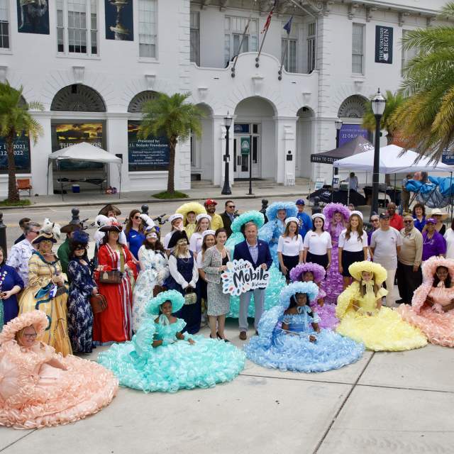 group of people gathered in front of the History Museum of Mobile.