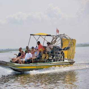 Group of people riding an airboat