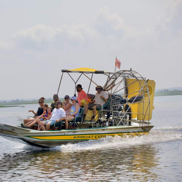 Group of people riding an airboat