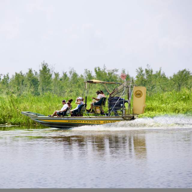 People riding in an airboat in the Mobile Bay
