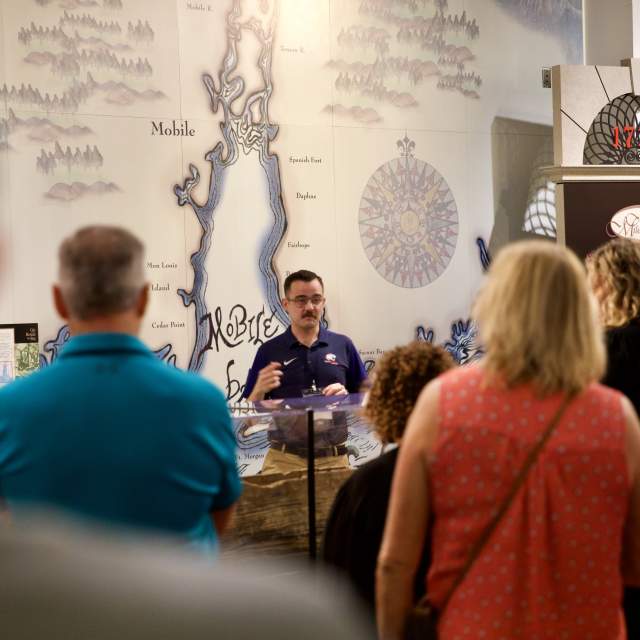 group of people listening to a presentation