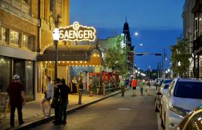 night time street view of the Saenger theatre with lighted, covered entrance