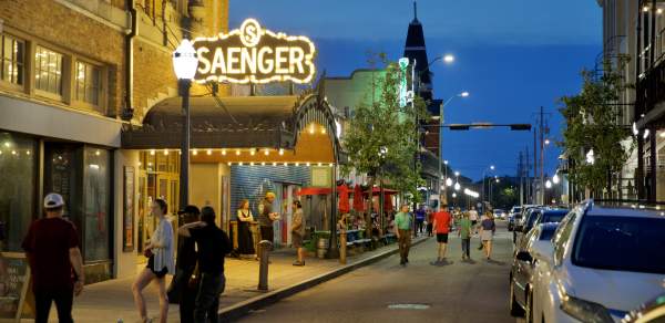 night time street view of the Saenger theatre with lighted, covered entrance