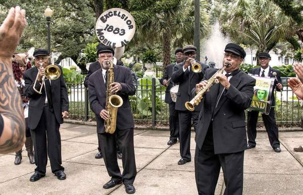 brass band playing in the park with people dancing
