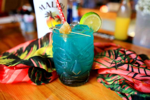 Blue drink in a totem pole face glass