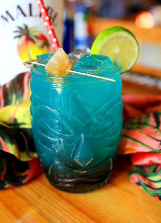 Blue drink in a totem pole face glass