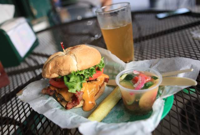 Bacon Cheeseburger, pickle spear, cup of tomato and cucumber salad