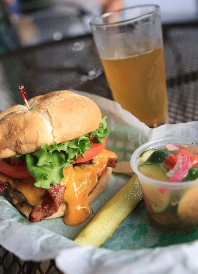 Bacon Cheeseburger, pickle spear, cup of tomato and cucumber salad