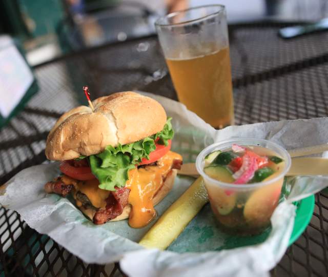 Bacon Cheeseburger, pickle spear, cup of tomato and cucumber salad