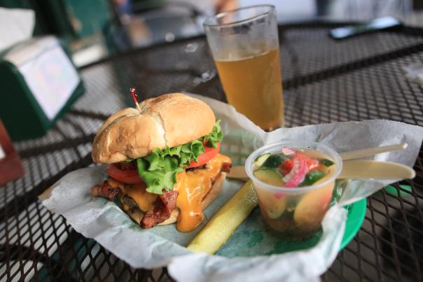Bacon Cheeseburger, pickle spear, cup of tomato and cucumber salad