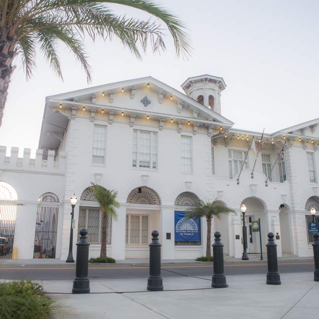 Exterior of the History Museum of Mobile and a palm tree