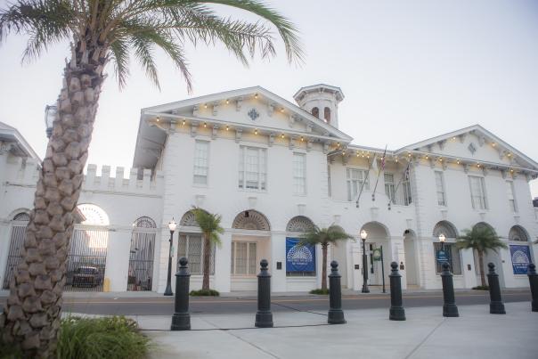 Exterior of the History Museum of Mobile and a palm tree