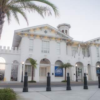 Exterior of the History Museum of Mobile and a palm tree