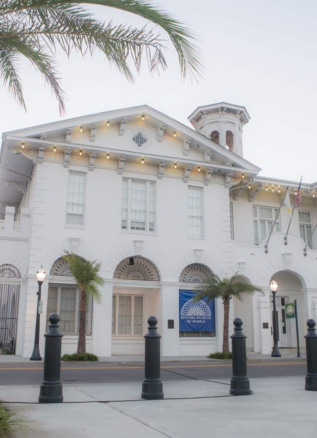 Exterior of the History Museum of Mobile and a palm tree