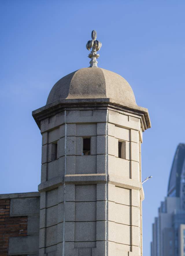Spire of Colonial Fort Condé with sky scrapers in the background in Mobile, AL