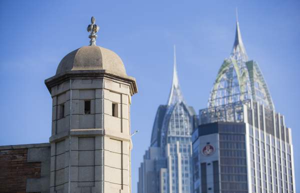 Spire of Colonial Fort Condé with sky scrapers in the background in Mobile, AL