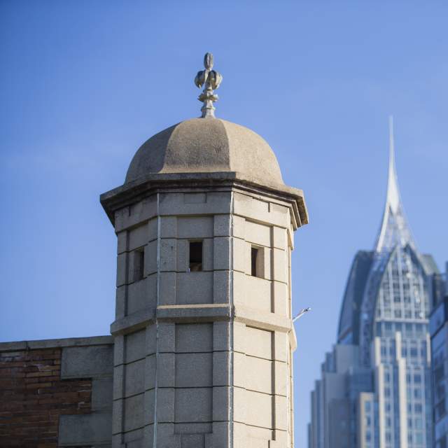 Spire of Colonial Fort Condé with sky scrapers in the background in Mobile, AL