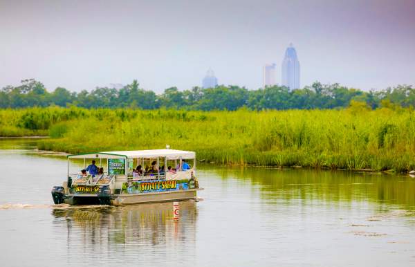 Safari tours boat in the Mobile Bay with the city in the background