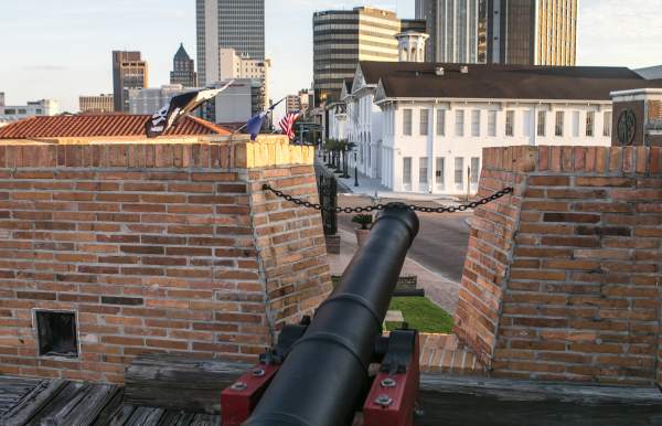 cannon at the Colonial Fort Conde in front of the cityscape