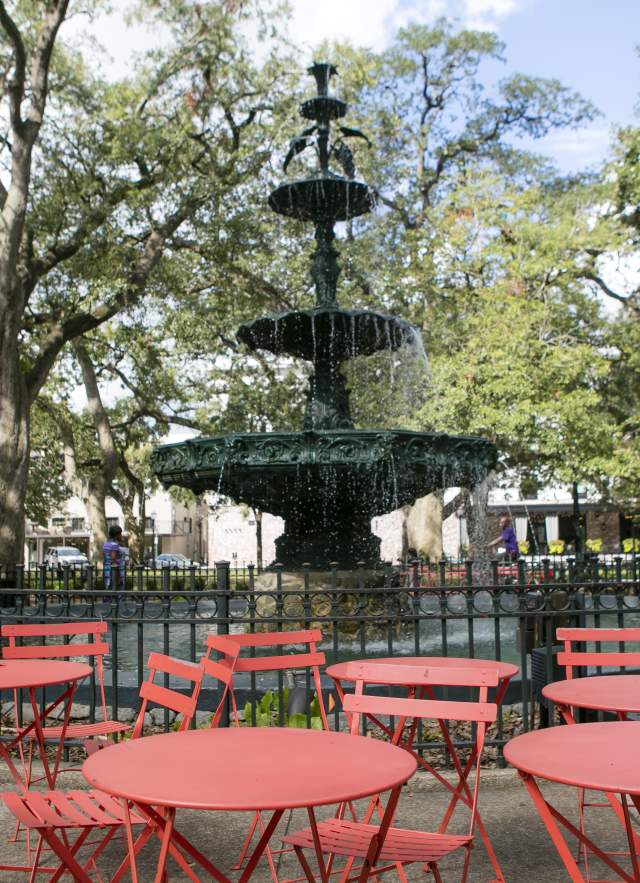 Bienville Square fountain with table and chairs in front