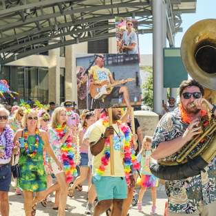 Second line parade featuring people with instruments and signs