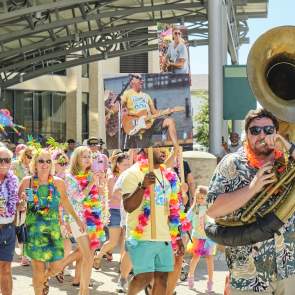 Second line parade featuring people with instruments and signs