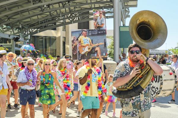 Second line parade featuring people with instruments and signs
