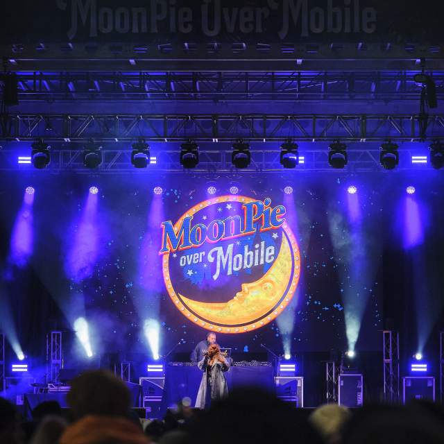 Performer on a purple lit stage with Moonpie logo