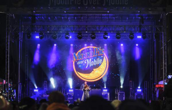 Performer on a purple lit stage with Moonpie logo