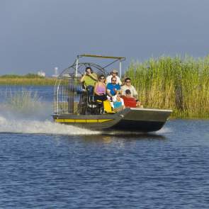 group of people riding on an airboat