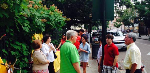group of people standing on a sidewalk