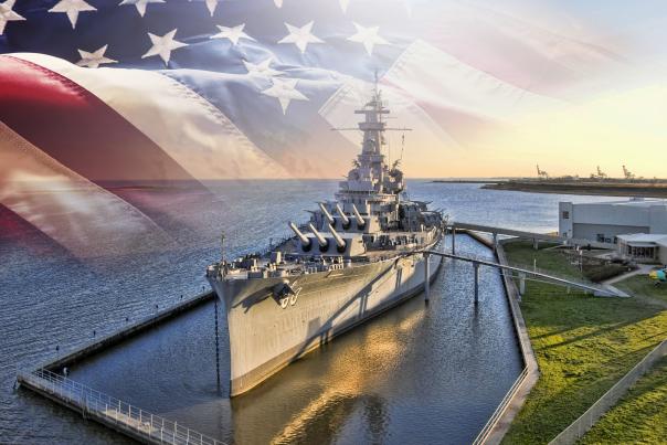 USS Alabama Battleship docked in Mobile Bay with an American flag
