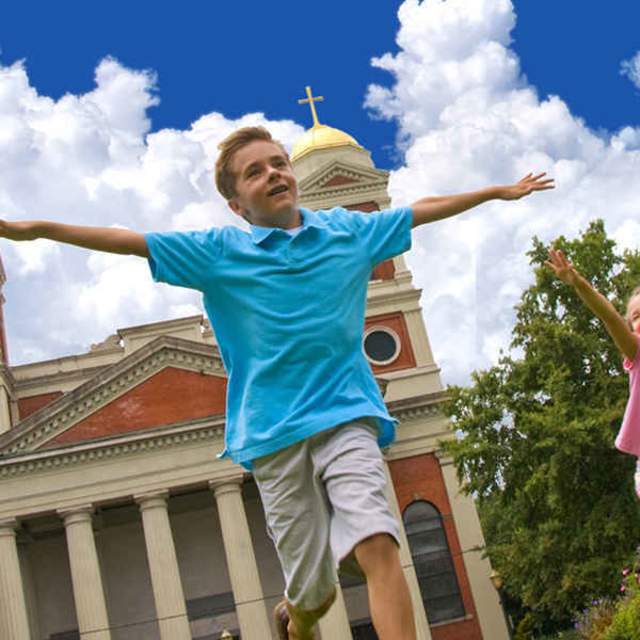 two children playing in front of a historic church in mobile alabama