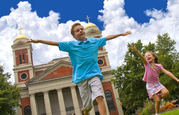 two children playing in front of a historic church in mobile alabama