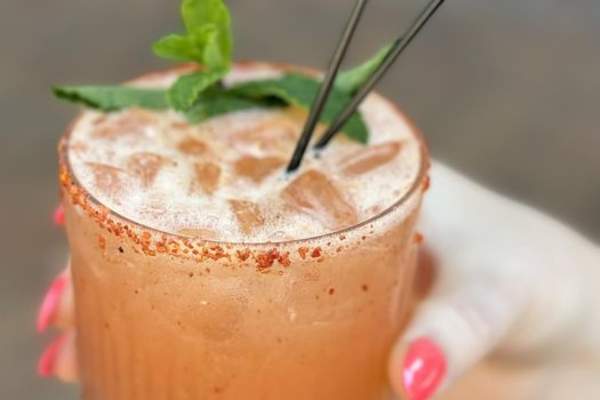 orange mixed drink with mint leaves