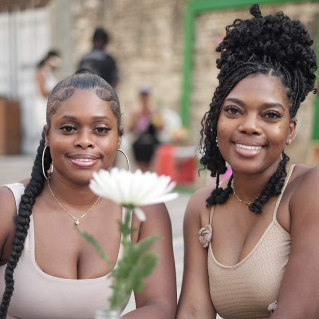 Two women sitting outside at a table