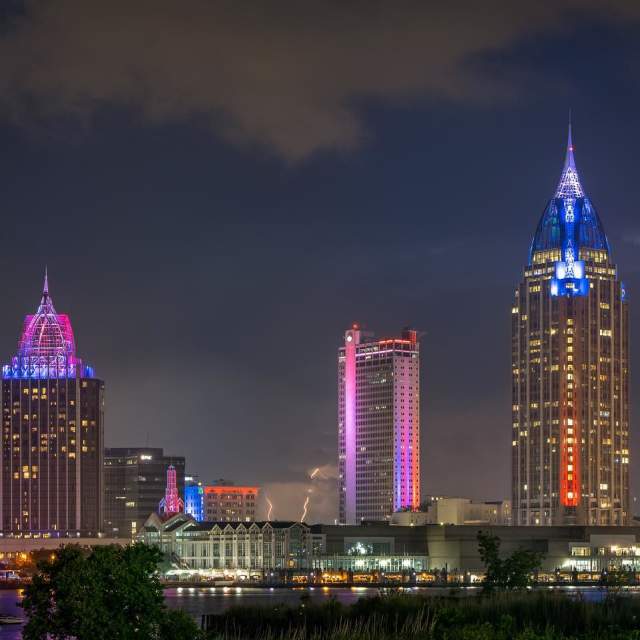 City of Mobile skyline at night with purple lights