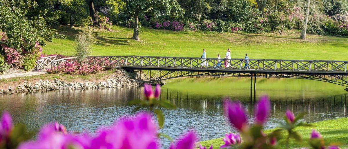 a family crossing a bridge over a river in mobile alabama