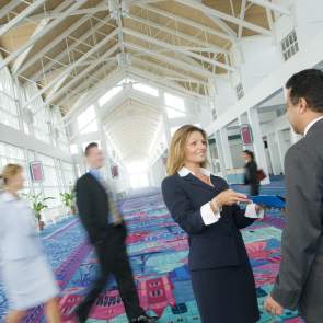 people in business suits talking in the main concourse of the Arthur R. Outlaw Convention Center