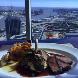 plate of food in front of an aerial view of the city from