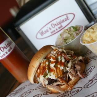 BBQ sandwich, macaroni and cheese, cole slaw and bbq sauce