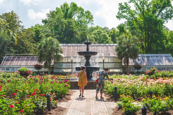 Two women walking amongst flowering plants
