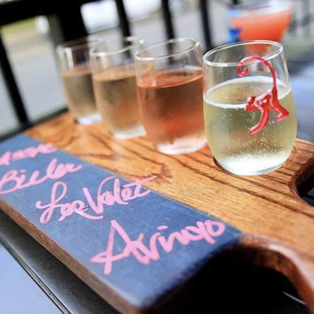 four wine glasses on a paddle