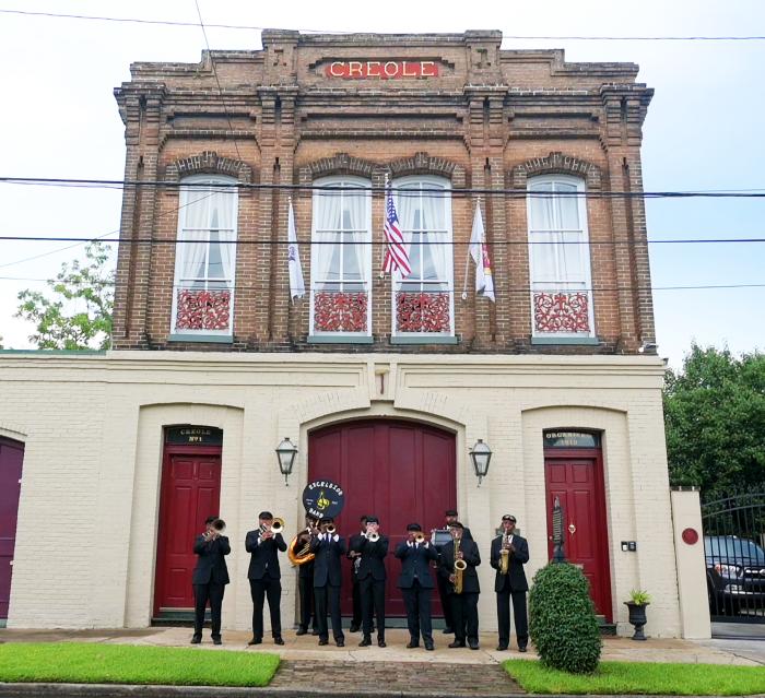 two story firehouse with Jazz band in front