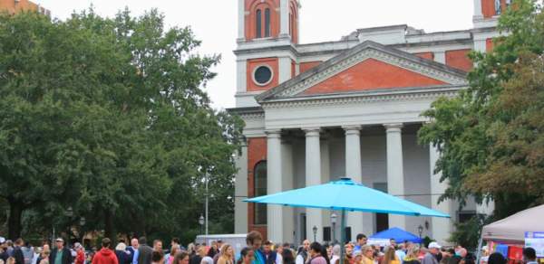 Cathedral Square: park with crowd of people in front of a large church