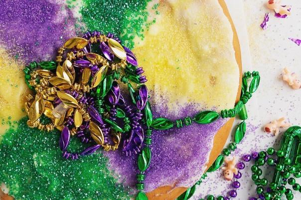 multi colored pastry with Mardi Gras beads on top