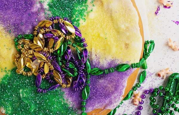 multi colored pastry with Mardi Gras beads on top
