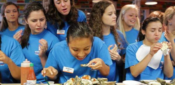 group of young women eating oysters
