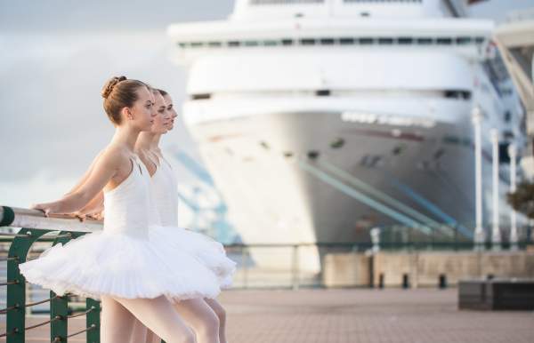 ballerinas from the mobile ballet posting in front of a cruise ship